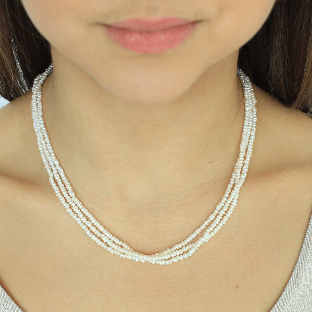 woman wearing freshwater pearl sterling silver 18k gold plated triple baroque pearl necklace