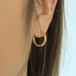 Load image into Gallery viewer, woman wearing 18k gold plated bamboo hoop earrings

