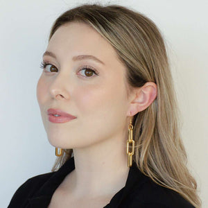 woman wearing stainless steel 18k gold triple link earrings