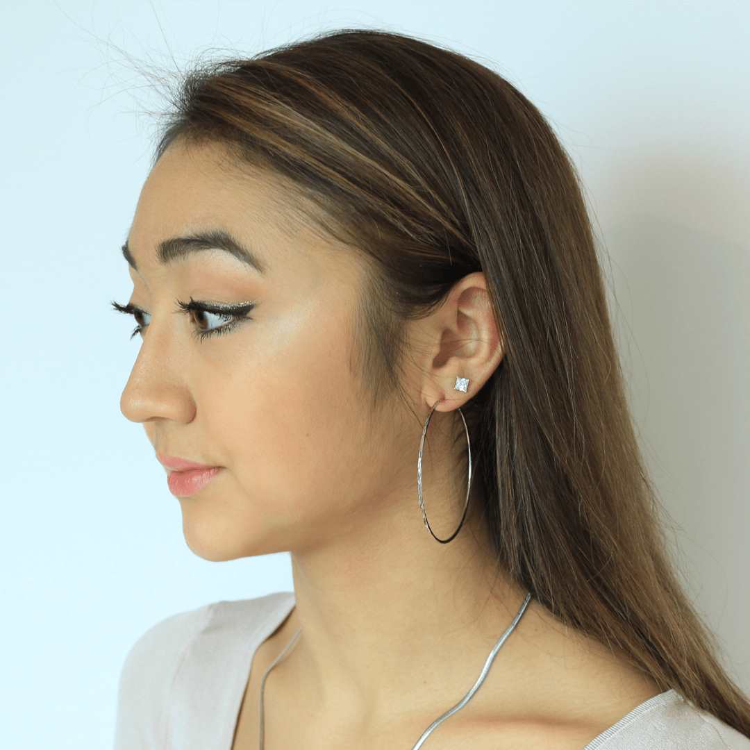 woman wearing sterling silver rhodium plated crushed hoop earrings