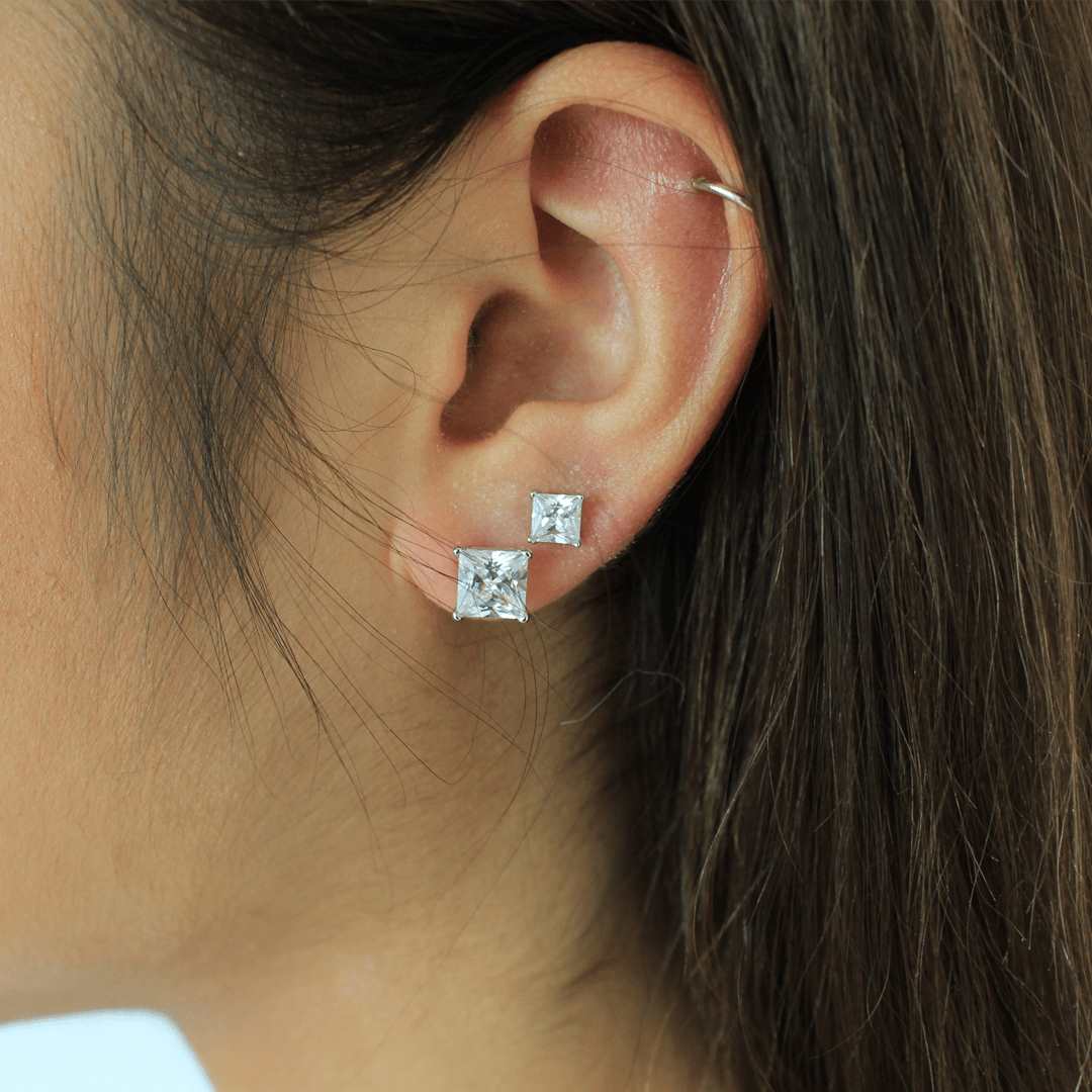 woman wearing sterling silver rhodium plated cubic zirconia square earrings size 7mm and 8mm