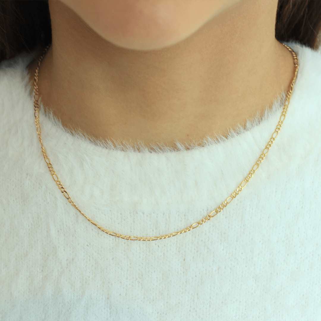 woman wearing sterling silver 18k gold plated figaro chain necklace