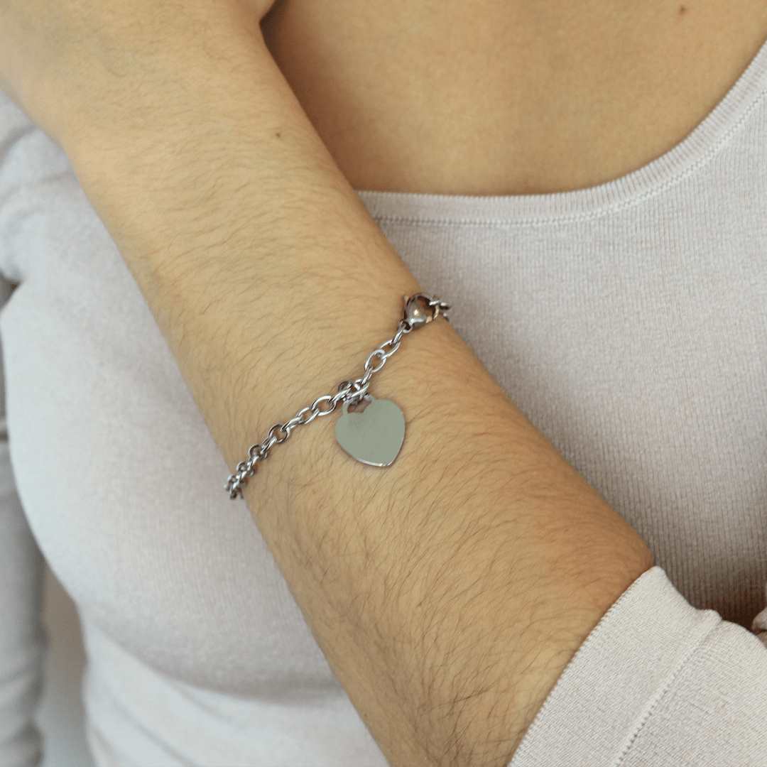 woman wearing stainless steel rhodium plated heart charm bracelet