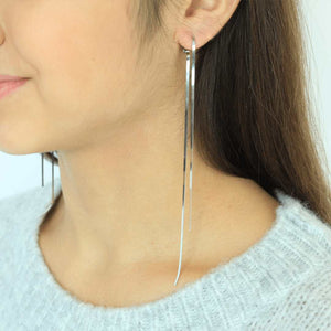 woman wearing sterling silver rhodium plated herringbone earrings