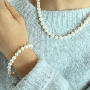 woman wearing freshwater pearl timeless pearl bracelet and necklace