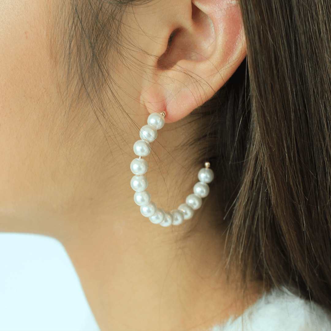 woman wearing freshwater pearls on a hoop earrings