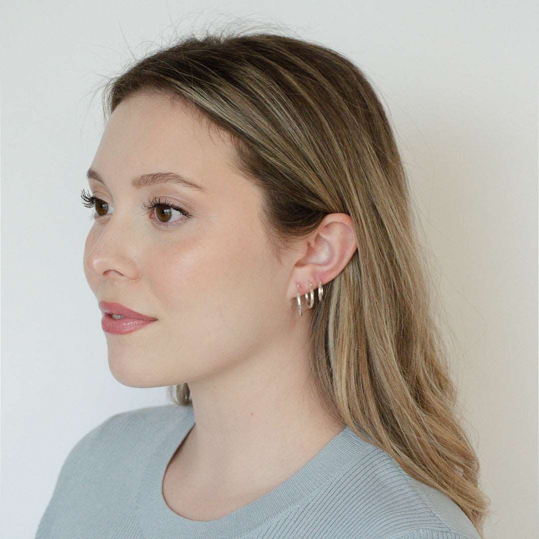 woman wearing sterling silver rhodium plated simply hoops