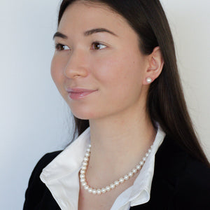 woman wearing freshwater pearl timeless pearl necklace and earrings